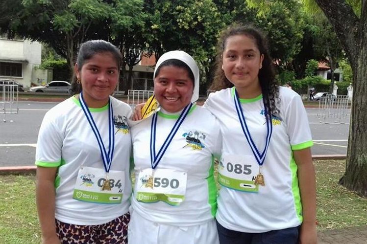Marta Alicia Caal Alcántara – al centro – junto a dos corredoras. (Foto Prensa Libre: Cortesía)