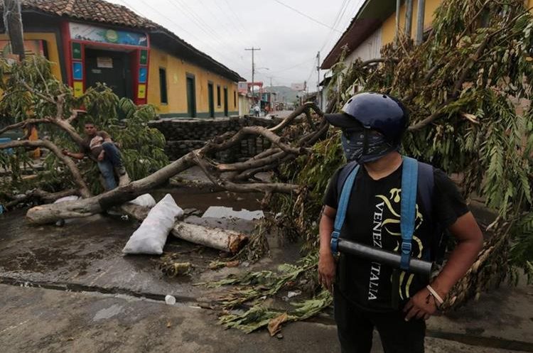 Manifestantes antigubernamentales permanecen en una barricada improvisada en la ciudad de Masaya, a 35 km de Managua.(AFP).