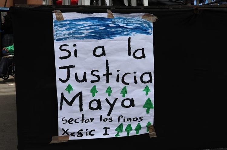 Un cartel que llevaba un comunitario muestra el respaldo a esa medida. (Foto Prensa Libre: Héctor Cordero)