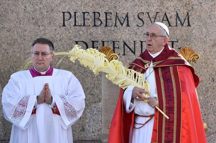 Pope Francis (R) leads the Palm Sunday mass at St Peter